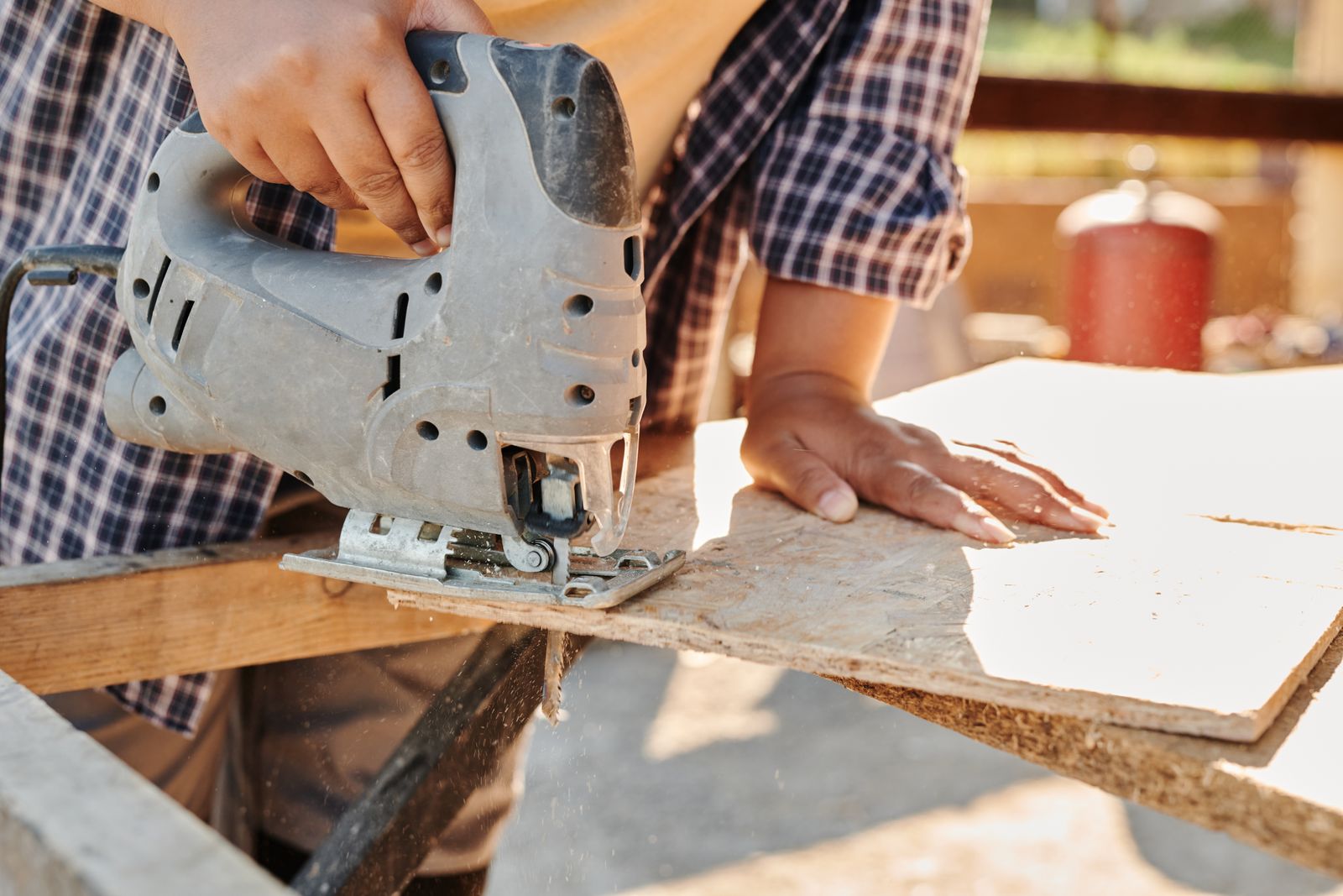 A tradesman cutting timber on site