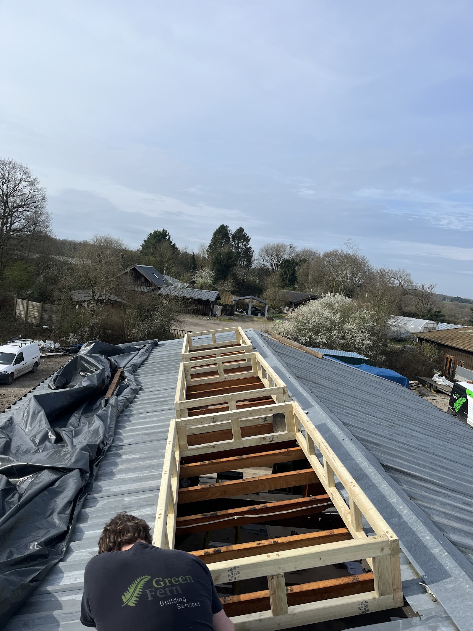 Dormer openings framed out on the roof — cut, squared and ready.